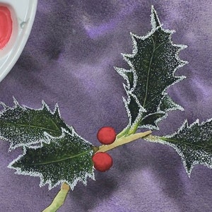 The sprig of leaves is now painted and complete, and Paul is working on the bright red berries.  He has applied a bright wash to both fruits, and has some darker paint in the palette shown on the left.