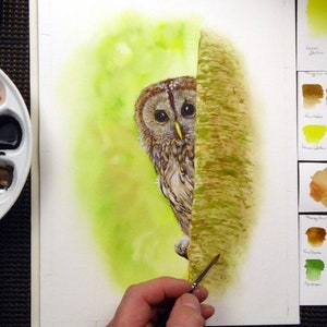 Paul finishing off the tree trunk with various colour washes, greens, browns and yellows.  His palette of colours is shown to the left, and his test sheets of colours on the right.