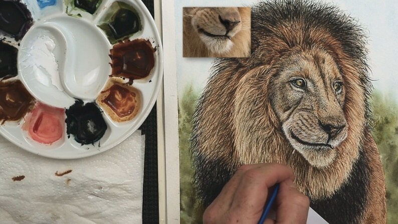 The lion looks almost complete, Paul is working with a white paint to add some fine highlighted hairs around the face.