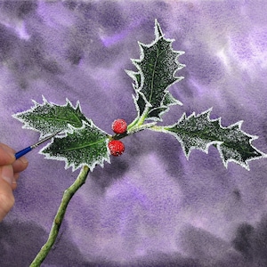 Paul's hand with a small brush in it is shown to the left, as he adds a white frosty edge to a sprig of holly he has painted in front of a purple background.  The leaves and berries are highly detailed and like an illustration.
