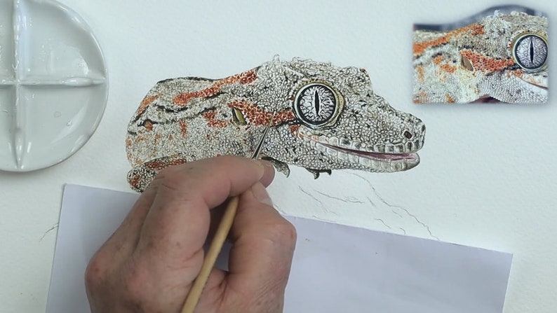 The lizard is almost finished in this photo, Paul is working in the fine details that are in orange and form lines along the length of the body.