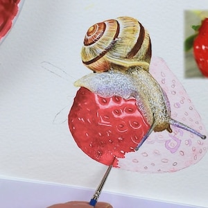 Paul is working on the strawberry under the snail, the fruit at the front of the snail has a pink wash applied to it, and the sections mapped out, but it is lacking the vibrant red detail as yet.
