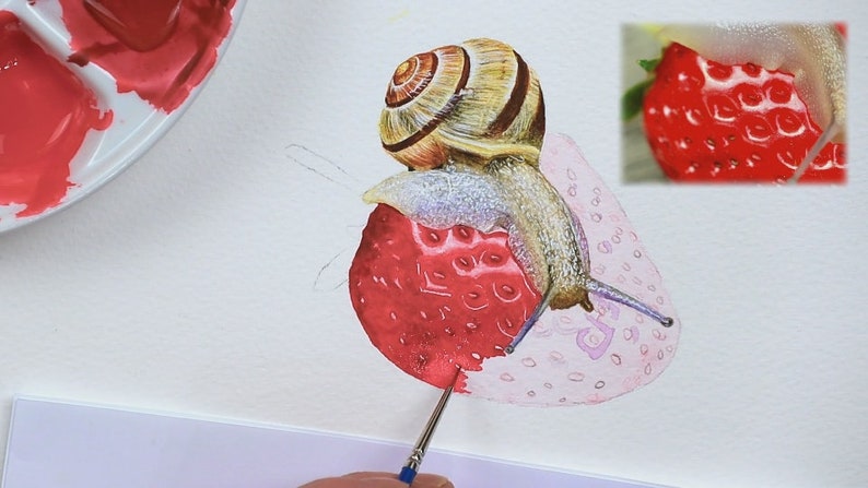 Paul is working on the strawberry under the snail, the fruit at the front of the snail has a pink wash applied to it, and the sections mapped out, but it is lacking the vibrant red detail as yet.