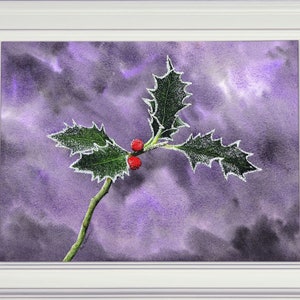 The completed painting of the holly leaves in a white frame.