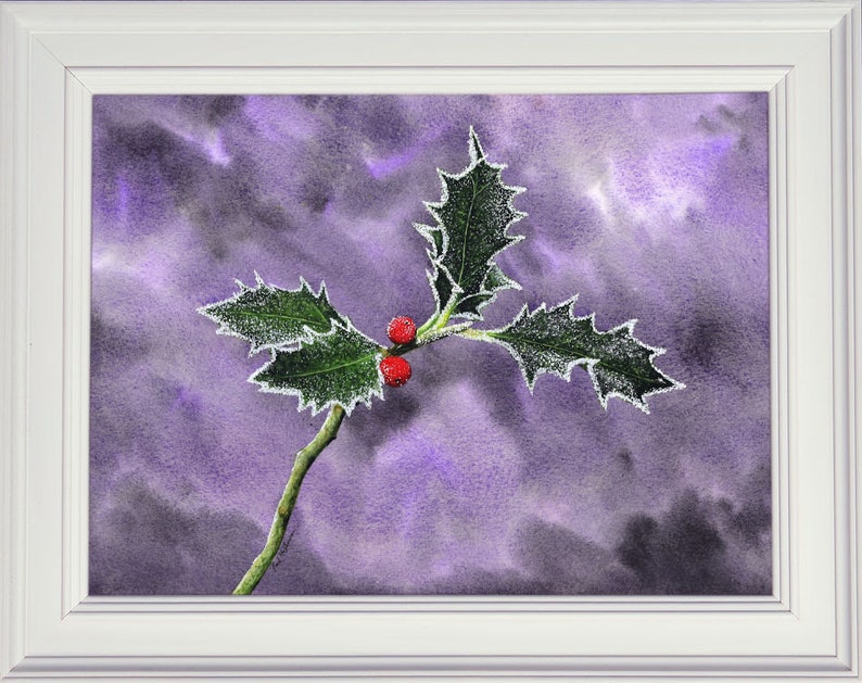 The completed painting of the holly leaves in a white frame.