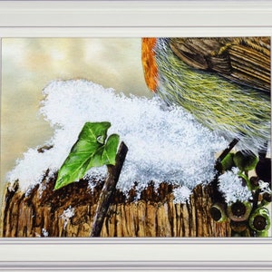 The snowy section of the painting shown in a white frame.