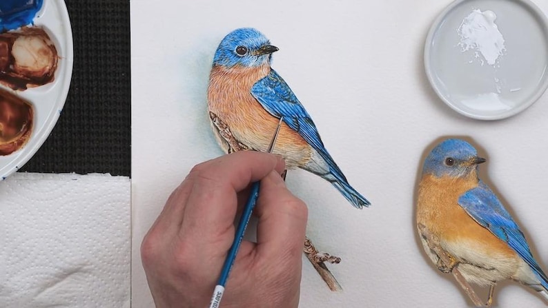 The bird  is nearing completion with Paul adding the white details over the top of all the darker details.  He is working on the wing, which has some paler edged feathers.