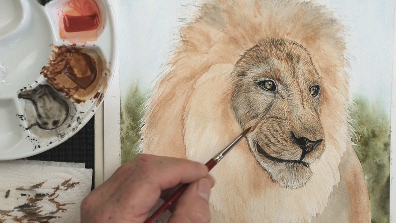 The wash is complete in this photo, and Paul is working with duller brown colours to apply the fur to the face.  This is surrounded by a huge mane, but this is yet to have detail added to it.