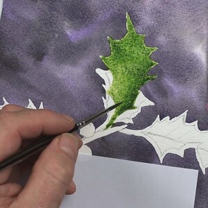 The background is painted and dry in this photo, and Paul is working with a smaller brush and some green paint to apply a bright wash to one of the leaves.