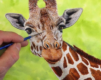 May include: Close-up of a giraffe's face, painted in watercolour. The giraffe has brown and white spots and a long neck. The artist is using a small brush to add details to the giraffe's fur.