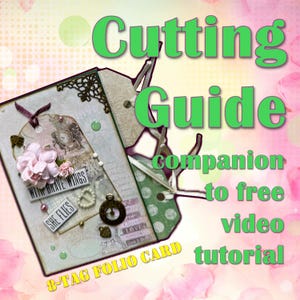 May include: A decorative 8-tag folio card with the text "Cutting Guide" and "companion to free video tutorial". The card features a tag with the text "With Brave Wings" and "She Flies", along with pink flowers and embellishments.