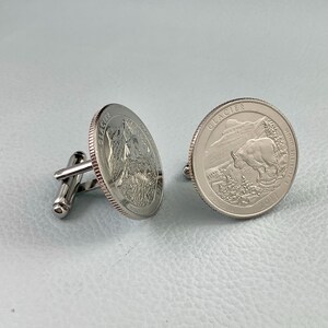 May include: A pair of silver cufflinks featuring the Glacier National Park quarter. The left cufflink is a close-up of the mountain scene, while the right cufflink shows the full quarter with the park's name and the year 2011.