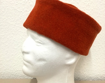 Cap crafted in orange wool fabric for medieval reenactment.