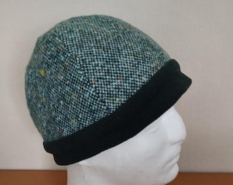 Four-panel hat made of dark green wool fabric, ornamented with a dark green wool band. Head circumference 60 cm.