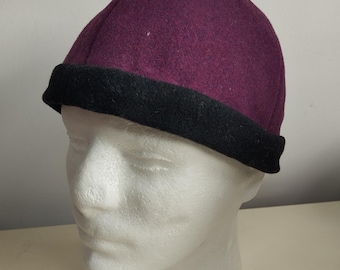 Four-panel hat made of red-wine wool fabric, ornamented with a wool band. Head circumference 60 cm.