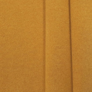 May include: A close-up of a piece of fabric in a rich mustard yellow colour. The fabric has a soft, fuzzy texture.