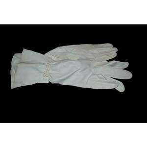 May include: A pair of white leather gloves with a button detail at the wrist.