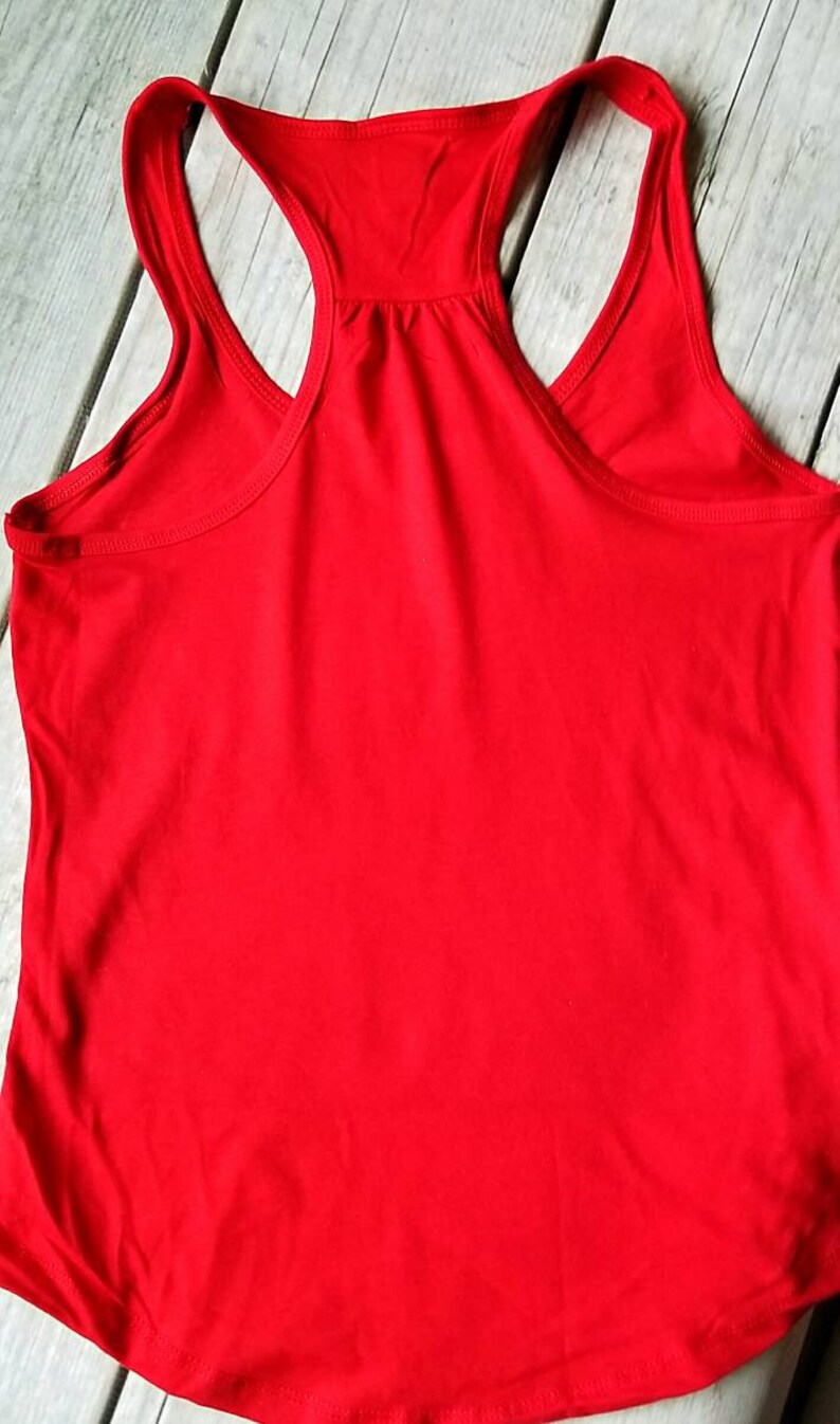 May include: A plain red tank top with a scoop neck and racerback style.