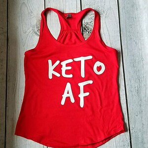 May include: Red tank top with white text that says "KETO AF".
