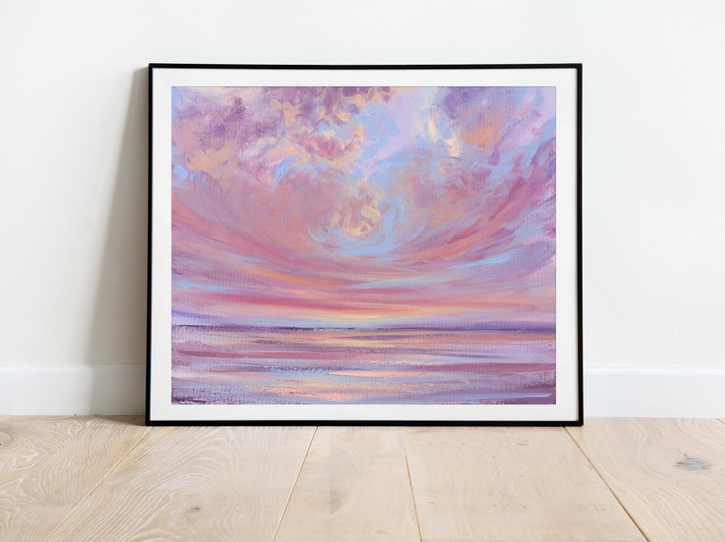 May include: A painting of a pink and purple sunset over a calm body of water. The sky is filled with fluffy clouds, and the water reflects the colors of the sky.