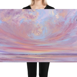 May include: A painting of a pink and purple sunset over a calm body of water. The sky is filled with soft, wispy clouds, and the water reflects the colors of the sky.