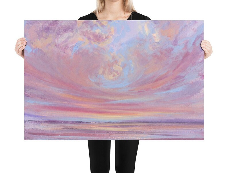May include: A painting of a pink and purple sunset over a calm body of water. The sky is filled with soft, wispy clouds, and the water reflects the colors of the sky.
