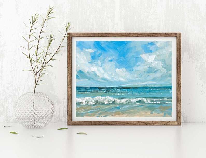May include: A framed painting of a seascape with blue water, white waves, and a light blue sky with white clouds.