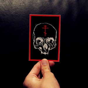 Monk Skull Vinyl Sticker - Black, White, and Red Monk Skull Decal with Red Cross 4.5&quot; x 3&quot;