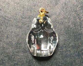 May include: A clear glass owl pendant with a gold-colored loop at the top.