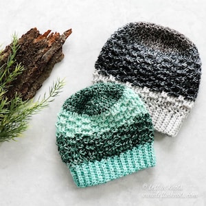 May include: Two crocheted hats, one in shades of green and teal, and the other in shades of gray and white.  The hats are made with a textured stitch and have a ribbed brim.