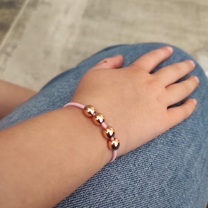 Back to school Kindergartener fidget stim bracelet Calming quiet discreet stimming toy Pink elastic with rose gold hematite beads