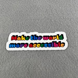 May include: A white sticker with the text "Make the world more accessible" in rainbow colors.