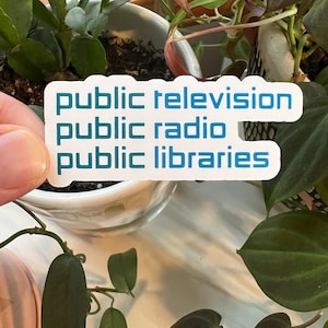 May include: White sticker with blue text that reads "public television public radio public libraries".