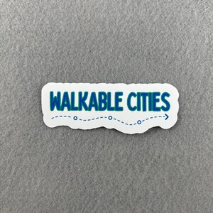 May include: White sticker with blue text that reads "WALKABLE CITIES" with a blue dotted line and arrow pointing to the right.