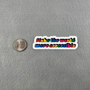 May include: A white sticker with the text "Make the world more accessible" in rainbow colors.