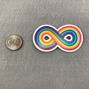May include: A rainbow infinity symbol sticker. The sticker is white with a rainbow colored infinity symbol. The sticker is about the size of a US quarter.
