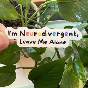 May include: White sticker with the text "I'm Neurodivergent, Leave Me Alone". The word "Neurodivergent" is in rainbow colors.