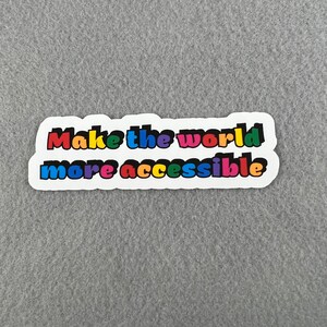 May include: A white sticker with the text "Make the world more accessible" in rainbow colors.
