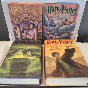 May include: Four hardcover books from the Harry Potter series by J.K. Rowling. The titles include Harry Potter and the Sorcerer's Stone, Harry Potter and the Prisoner of Azkaban, Harry Potter and the Half-Blood Prince, and Harry Potter and the Deathly Hallows.