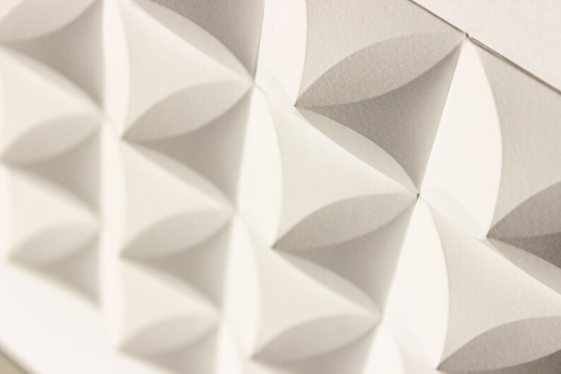 May include: White acoustic panels with a geometric pattern of overlapping circles. The panels are made of a textured material and have a slightly raised surface.