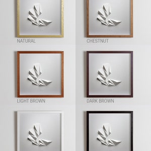 May include: A white paper sculpture of a geometric shape in a frame. The frame is available in six colors: natural, chestnut, light brown, dark brown, white, and black.