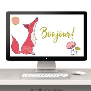 May include: A desktop computer screen displaying a digital wallpaper with a red fox, a sun, a mushroom, and the text "Bonjour!" The computer is on a white desk with a keyboard, mouse, and a green desk lamp.