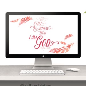 May include: Desktop wallpaper featuring a pink and white watercolor background with the text "Be still and know that I am God" in pink lettering. The text is surrounded by pink feathers.