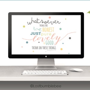 May include: A desktop computer screen displaying a motivational quote: "whatsoever things are true honest just pure lovely & good think on these things". The quote is written in a colorful, handwritten font with a confetti background. The computer is on a white desk with a green desk lamp.