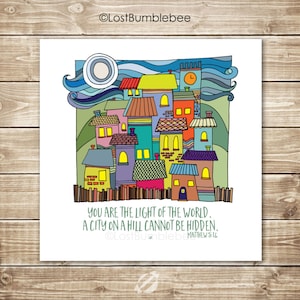 May include: A colorful illustration of a city on a hill with the text "You are the light of the world. A city on a hill cannot be hidden. Matthew 5:14".