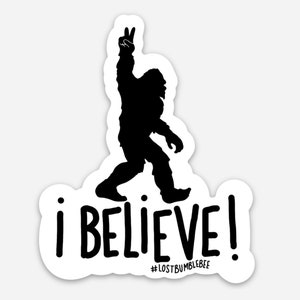 May include: Black and white sticker featuring a silhouette of Bigfoot raising his hand in a peace sign. The text "i BELIEVE!" is below the silhouette, with the hashtag "#LOSTBUMBLEBEE" underneath.