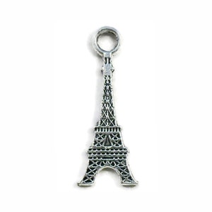 May include: Silver charm in the shape of the Eiffel Tower with a loop at the top for attaching to a bracelet or necklace.
