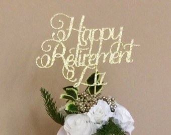 May include: A gold glitter "Happy Retirement" sign on a green glass bottle with white flowers and greenery.