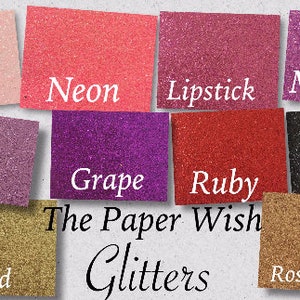 May include: A collection of glitter paper samples in various colors, including blush, neon, lipstick, magic, plum, grape, ruby, onyx, gold, and rose gold. The text "The Paper Wish Glitters" is printed below the samples.
