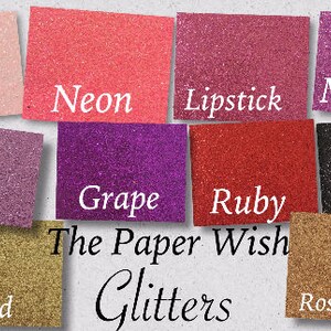 May include: A collection of glitter paper samples in various colors, including blush, neon, lipstick, magic, plum, grape, ruby, onyx, gold, and rose gold. The text "The Paper Wish Glitters" is printed below the samples.